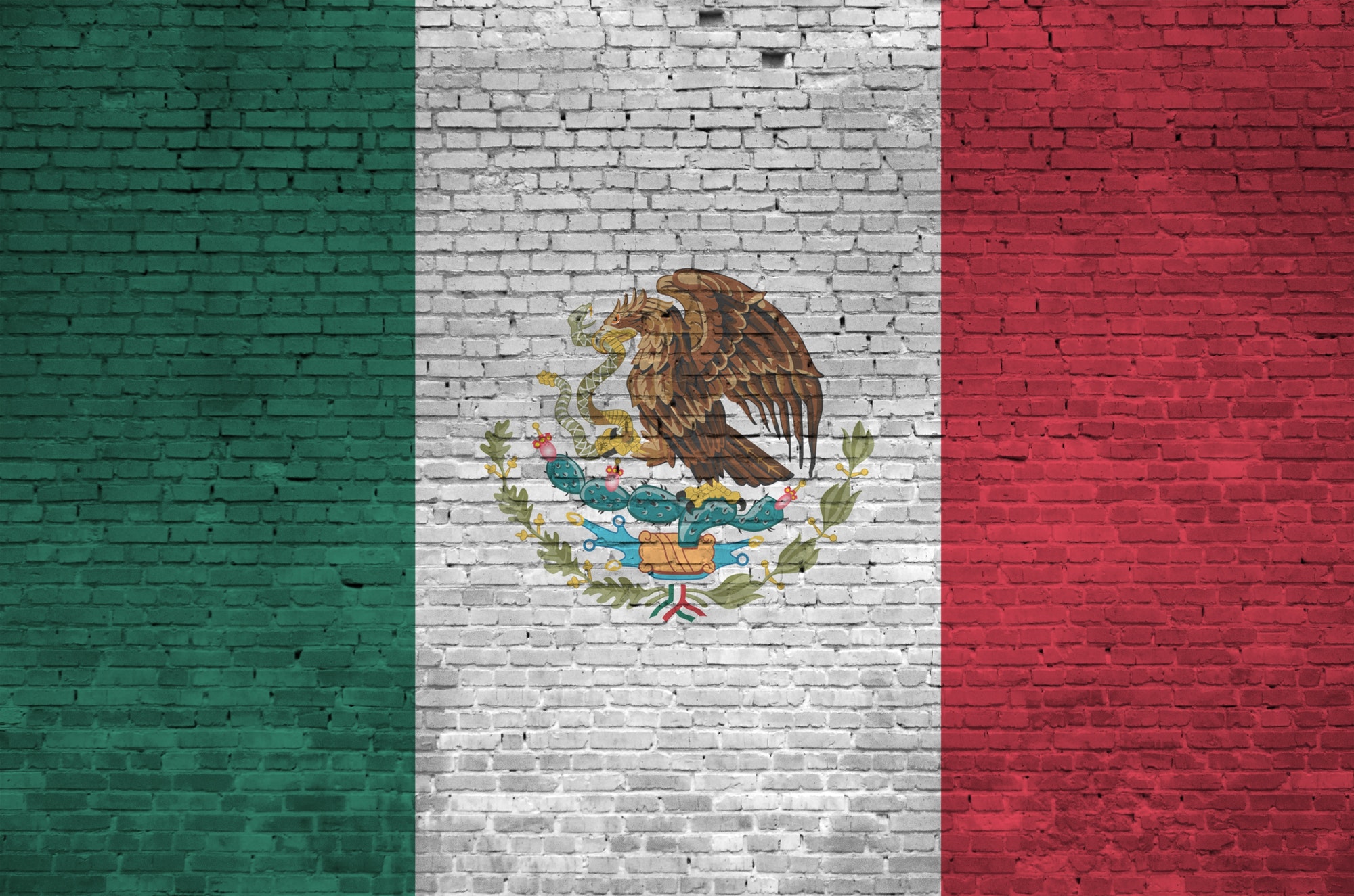 Mexico flag depicted in paint colors on old brick wall close up